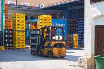 brewery, monastery brewery, reutberg, brewery cooperative, forklift, building, patio, warehouse, truck, loading, beer barrels, crates, stacked, forklift, forklift, forklift, forklift, forklift