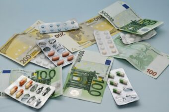 a pile of pills and money sitting on top of a table